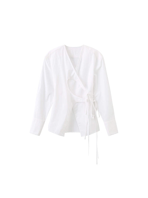 A white long-sleeve wrap-style blouse with a ruffled V-neckline and a side tie detail, shown against a plain white background.